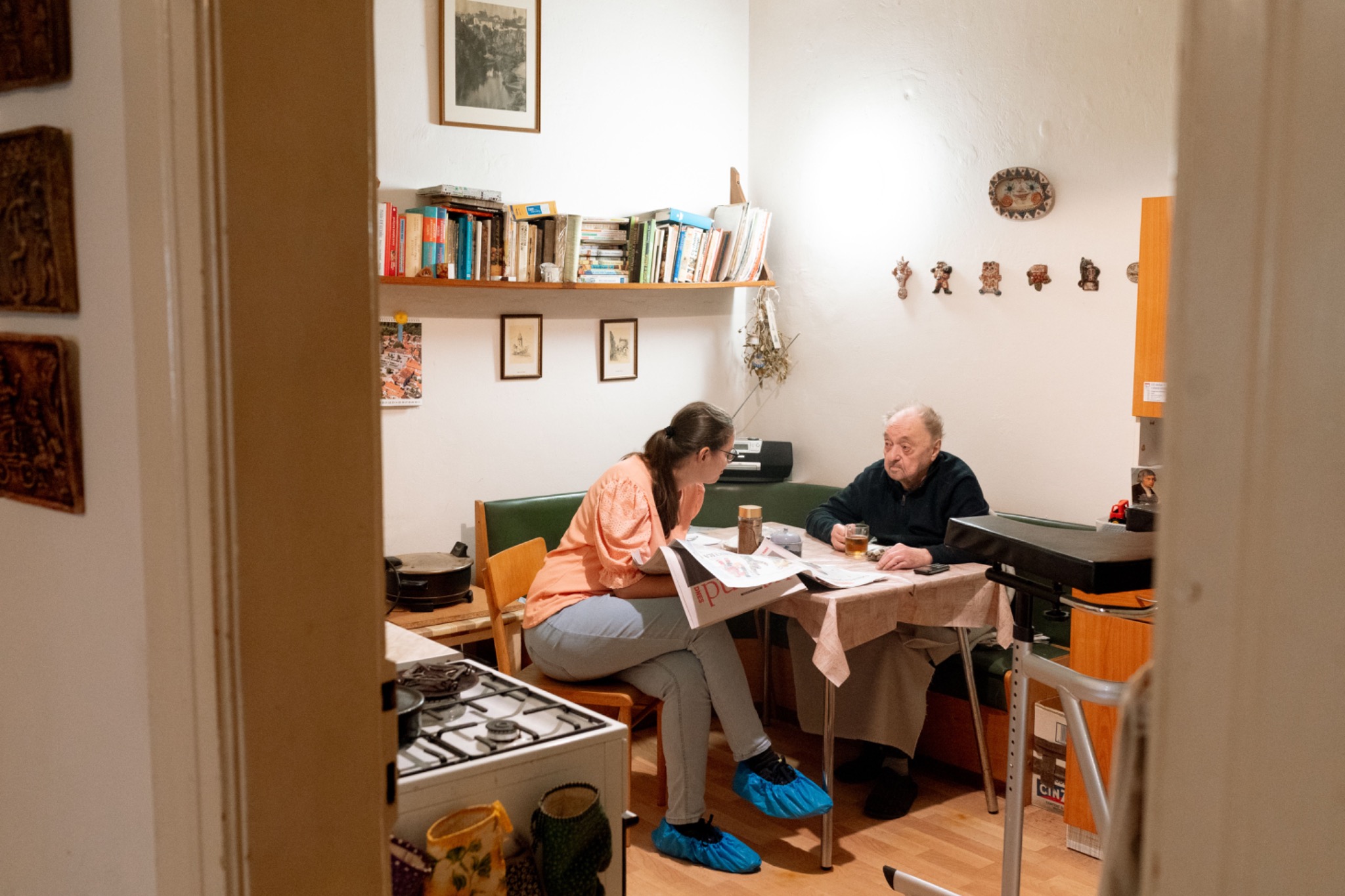 Caregiver providing companionship to an older adult at home