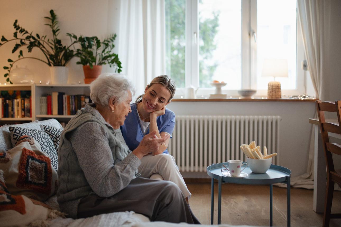 Caregiver and older adult sharing companionship at home